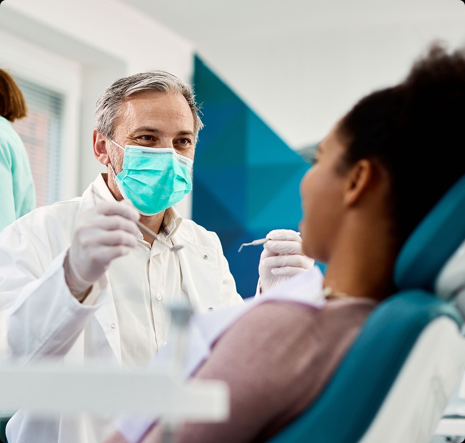 Mature dentist with patient