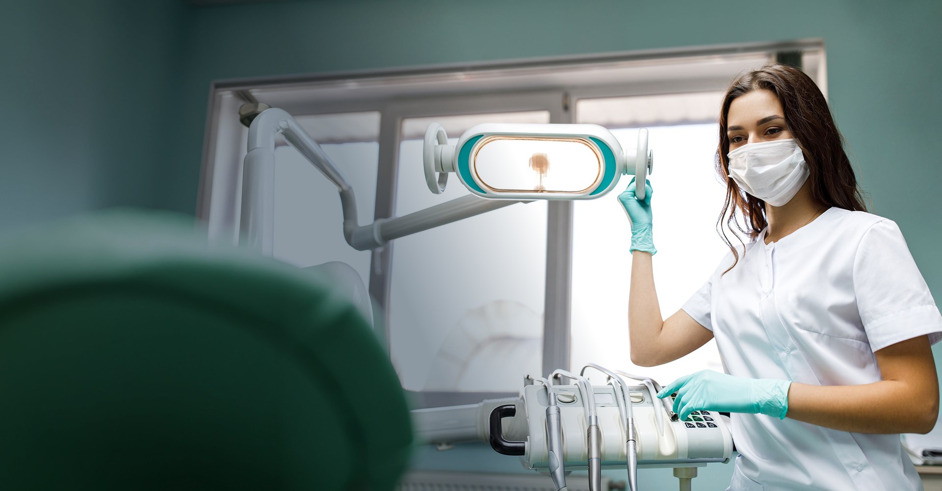 Young dentist with patient at clinic